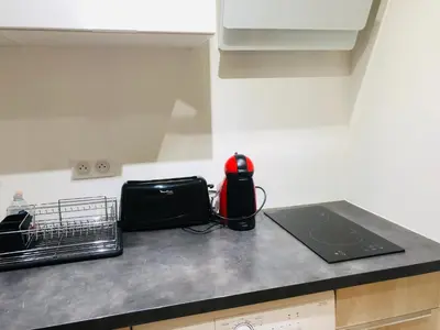 a kitchen with a washer and dryer in a room at 