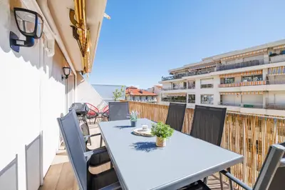 a table and chairs on the balcony of a building at Le Hammam Azur in Nice