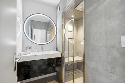 a bathroom with a sink and a mirror at Le Hammam Azur in Nice