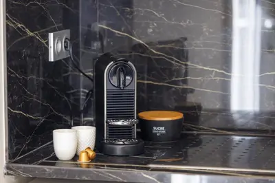 a coffee maker sitting on a counter with two cups at Le Hammam Azur in Nice
