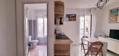 a kitchen and dining room with a table and chairs at Nice Studio With View Near Beach in Nice