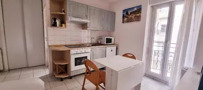a small kitchen with a table and a stove at Nice Studio With View Near Beach in Nice