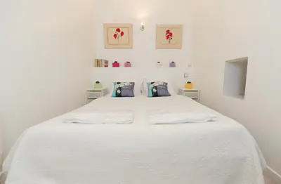 a white bedroom with a large white bed at PV STUDIO Five Stars Holiday House in Nice