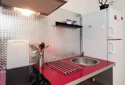 a kitchen with a sink and a red counter top at PV STUDIO Five Stars Holiday House in Nice