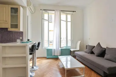 a living room with a couch and a table at Appartement Lamartinesque - Welkeys in Nice