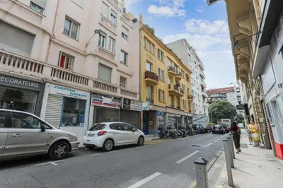 a city street with cars parked on the side of the road at Appartement Lamartinesque - Welkeys in Nice