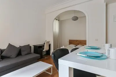 a living room with a couch and a table at Appartement Lamartinesque - Welkeys in Nice
