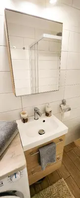 a bathroom with a sink and a mirror at STUDIO- NICE MONT BORON, PISCINE SUR LA RESIDENCE in Nice