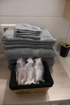 a basket filled with clothes and a pile of towels at STUDIO- NICE MONT BORON, PISCINE SUR LA RESIDENCE in Nice
