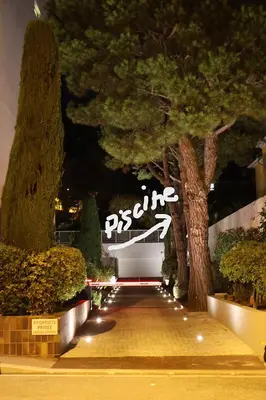 a bench in a park with a lit up sign at STUDIO- NICE MONT BORON, PISCINE SUR LA RESIDENCE in Nice