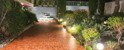 a brick walkway with benches and plants in a building at STUDIO- NICE MONT BORON, PISCINE SUR LA RESIDENCE in Nice