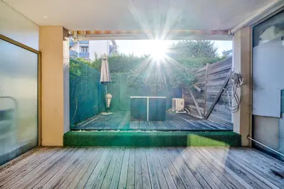 a balcony with a table on a wooden floor at Charmant studio in Cagnes-sur-Mer