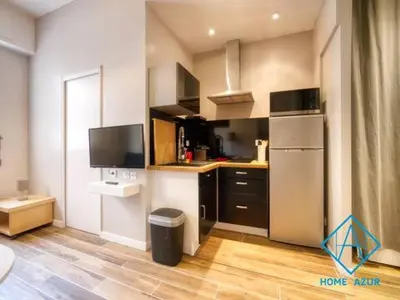 a kitchen with a refrigerator and a counter top at Port de Nice- Résidence Neptune- Superbe studio! in Nice
