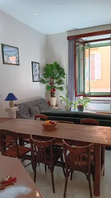 a living room with a wooden table and chairs at L'anthurium de l'Opéra in Nice