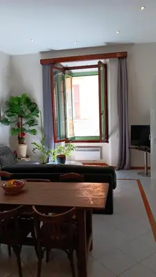 a living room with a couch and a table at L'anthurium de l'Opéra in Nice