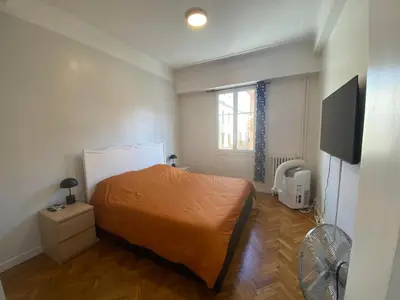 a bedroom with a bed and a television in it at Charmant 2 pièces - hypercentre, proche mer in Nice