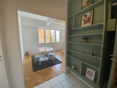 a dining room with a table and a table and chairs at Charmant 2 pièces - hypercentre, proche mer in Nice