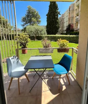 a table and two chairs sitting on a balcony at Nice Apartement 20 mins from the beach in Nice