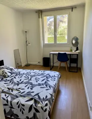 a bedroom with a bed and a desk and a window at Nice Apartement 20 mins from the beach in Nice