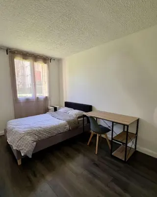 a bedroom with a bed and a desk and a table at Nice Apartement 20 mins from the beach in Nice