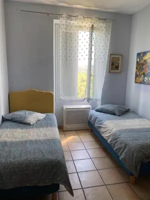 a bedroom with two beds and a window at Maison le Rêve in Falicon