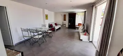 a living room with a table and chairs at Perle in Nice