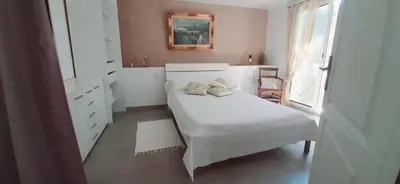 a white bedroom with a bed and a window at Perle in Nice