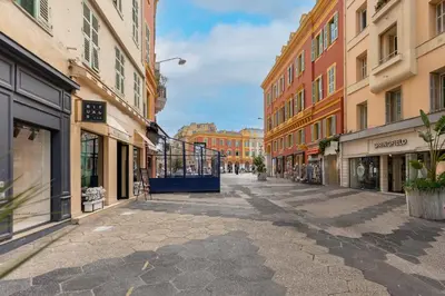 an empty street in a city with buildings at AZUR Apartment - Quiet City Center Location by the Sea in Nice