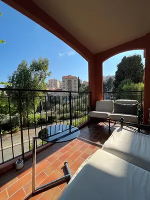 a balcony with a couch and a bench at 2 pièces avec terrasse en résidence privée in Nice