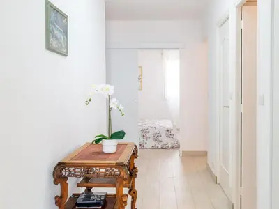 a room with a table with a flower on it at Apartment Les Trois Caps by Interhome in Cagnes-sur-Mer