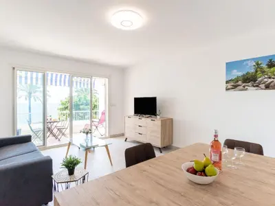 a living room with a table with a bowl of fruit at Apartment Les Trois Caps by Interhome in Cagnes-sur-Mer