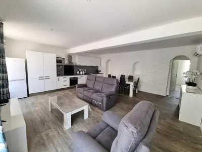 a living room with two couches and a table at Bel appartement 2 chambres climatisé centre ville in Nice