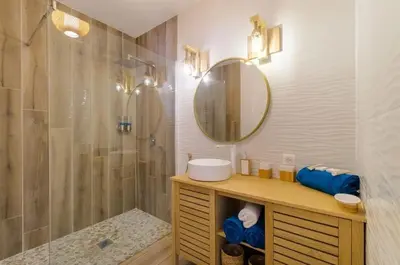 a bathroom with a shower and a sink and a mirror at Magnifique pavillon indépendant T2 Nice in Nice