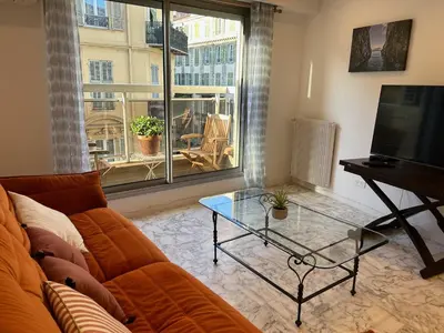 a living room with a couch and a glass table at Nice la Belle, city centre 1 bed, 2 terrace, quiet in Nice