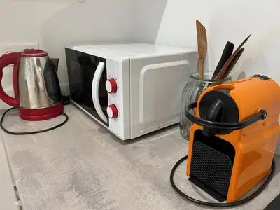 an orange and white microwave sitting on a counter at Nice la Belle, city centre 1 bed, 2 terrace, quiet in Nice