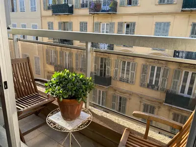 a balcony with two chairs and a potted plant at Nice la Belle, city centre 1 bed, 2 terrace, quiet in Nice