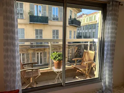 a window view of a balcony with chairs and a plant at Nice la Belle, city centre 1 bed, 2 terrace, quiet in Nice