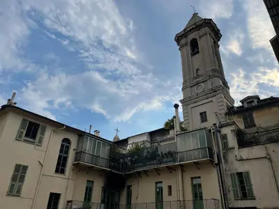 a building with a tower with a clock on it at Summerhouse 2 bed quiet Old Nice balcony100m beach in Nice