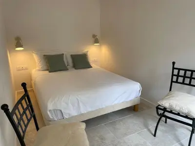 a bedroom with a white bed with two green pillows at Summerhouse 2 bed quiet Old Nice balcony100m beach in Nice