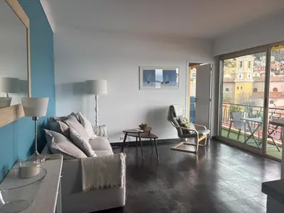 a living room with a couch and a balcony at Excellent location - Sea Views in Villefranche-sur-Mer