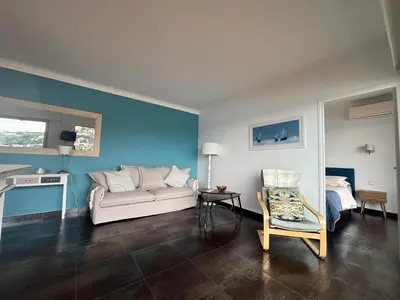 a living room with a couch and a chair at Excellent location - Sea Views in Villefranche-sur-Mer