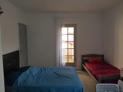 a bedroom with a bed and a window at studio pour 3 personnes au calme dans villa in Nice