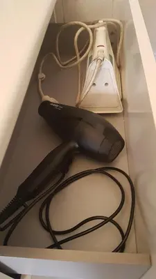 a black hairdryer and a lamp in a box at studio pour 3 personnes au calme dans villa in Nice