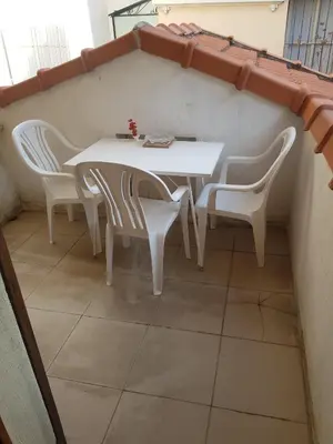 a white table and chairs in a room at studio pour 3 personnes au calme dans villa in Nice
