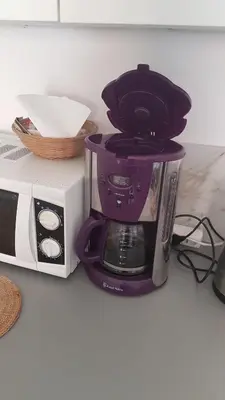 a purple coffee maker on a counter next to a microwave at studio pour 3 personnes au calme dans villa in Nice