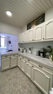 a kitchen with white cabinets and a counter top at appartement cosy - 2 chambres, situé en Centre Ville in Nice