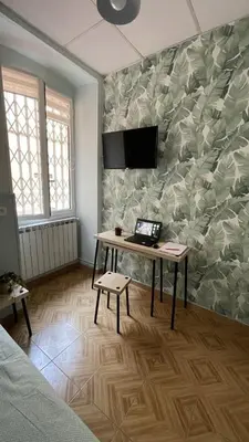 a room with a table and a tv on a wall at appartement cosy - 2 chambres, situé en Centre Ville in Nice
