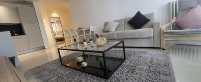 a living room with a couch and a glass table at cagnes promenade in Cagnes-sur-Mer