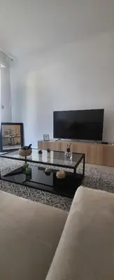 a living room with a tv and a coffee table at cagnes promenade in Cagnes-sur-Mer