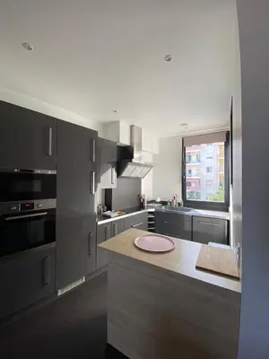 a shower with black walls and a shower head at Appartement Nice Promenade in Nice